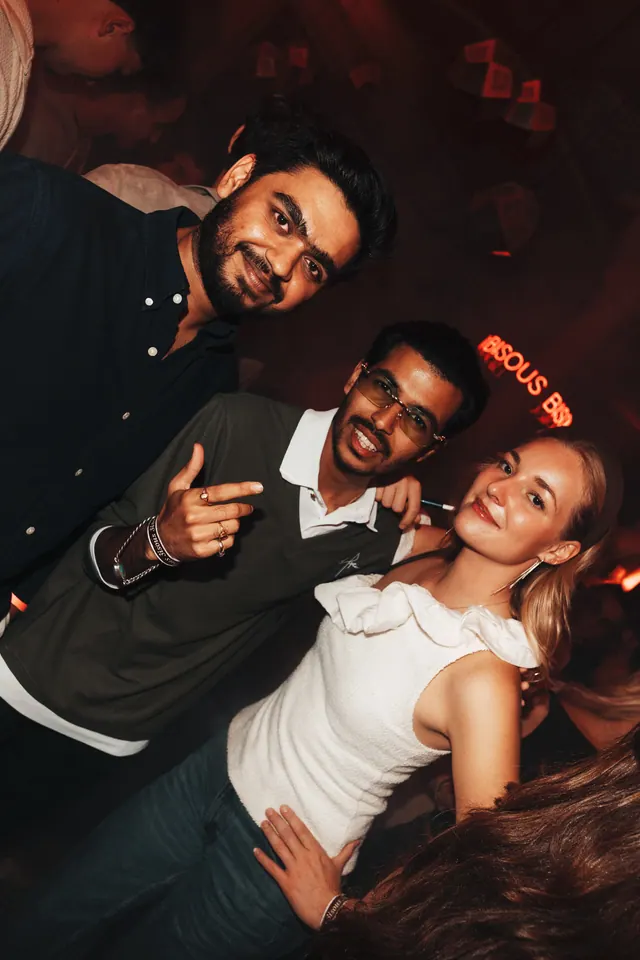 Three guests posing together during the night