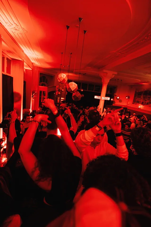 The crowd dancing under red lights at Le Moderne